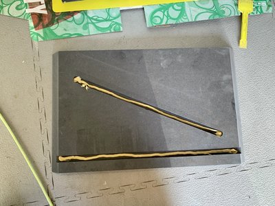 Een strook lijm word aangebracht in de sleuven van de rechter zijkant. Deze word vervolgens aangebracht en met spanband naar elkaar toe getrokken. Zie ook foto’s van gisteren. Doordat de schuine brace in gleuf valt van de zijkanten en achter tussenschot in gleuf van zijkanten en boven en onderkant, gaat door aantrekken van de spanband, alle naden vanzelf goed staan. De 45 graden verstek buiten naden sluiten echt perfect.